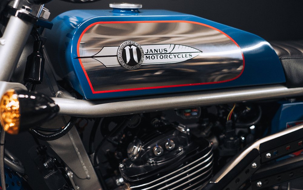 studio photo of blue Janus fuel tank with red pinstripe and polished bare aluminum section on the sides of the tank