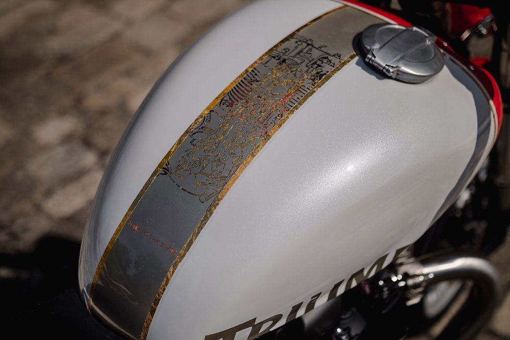 close view of the white tank with gold leaf decoration and red sections