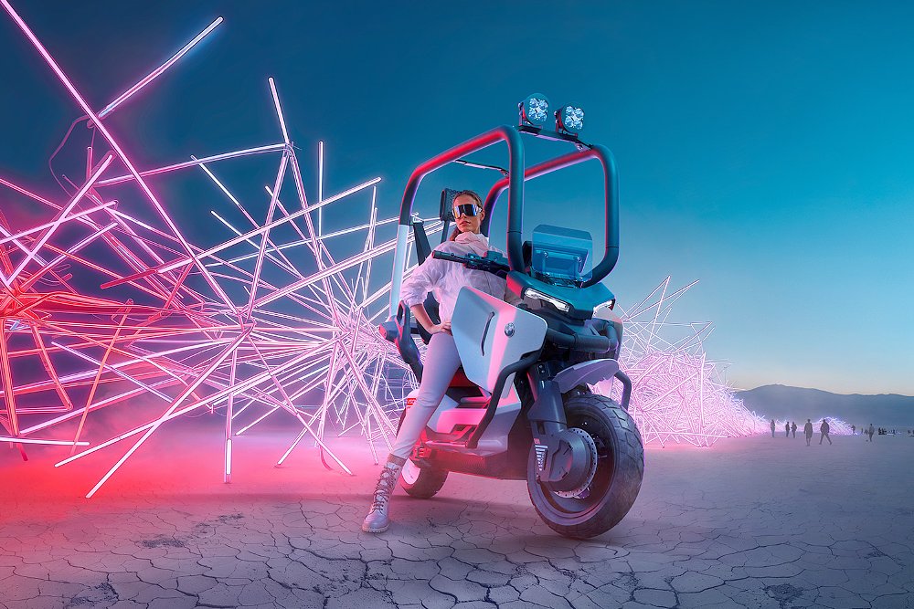 A stylish female rider mounted on BMW's Vision CE e-scooter concept with a light installment in the background.