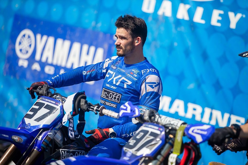 Coty Schock in blue Yamaha gear sitting on his motorcycle at the starting gate before a race