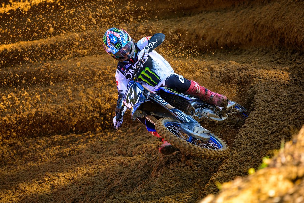 Justin Cooper racing through a berm at an outdoor Pro Motocross race