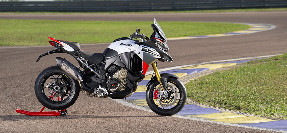 silver and red Multistrada V4 RS parked on a track stand on a race track