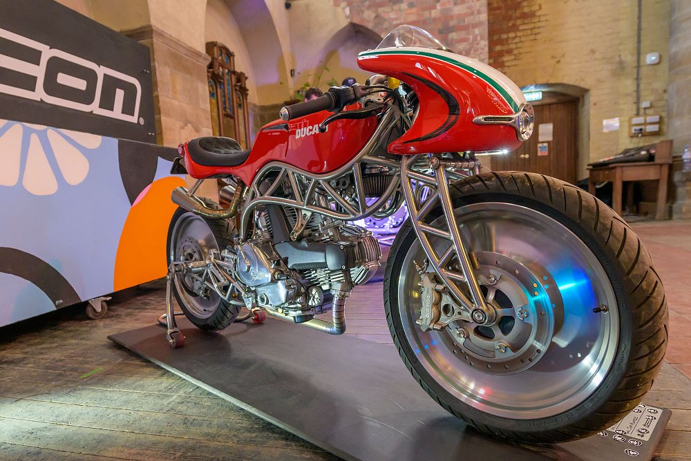 red Ducati with a curved trellis frame