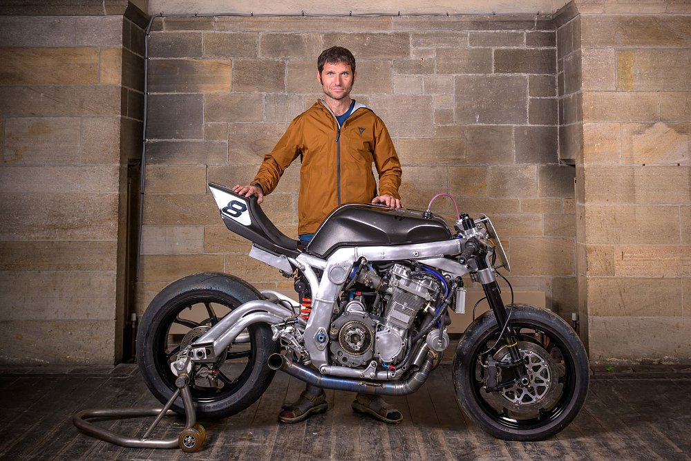 racer Guy Martin posing with his custom Suzuki