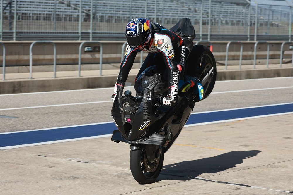 World Superbike Champion Toprak Razgatlioglu perfroms a stoppie on a 2025 alpha Racing M 1000 RR in pit lane at Circuit of the Americas in Austin, Texas.