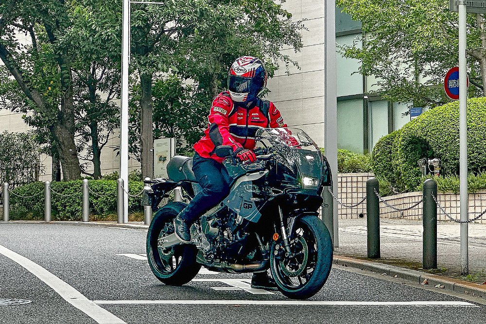 Dustin mounted on the XSR900 GP at a stop sign in Tokyo.