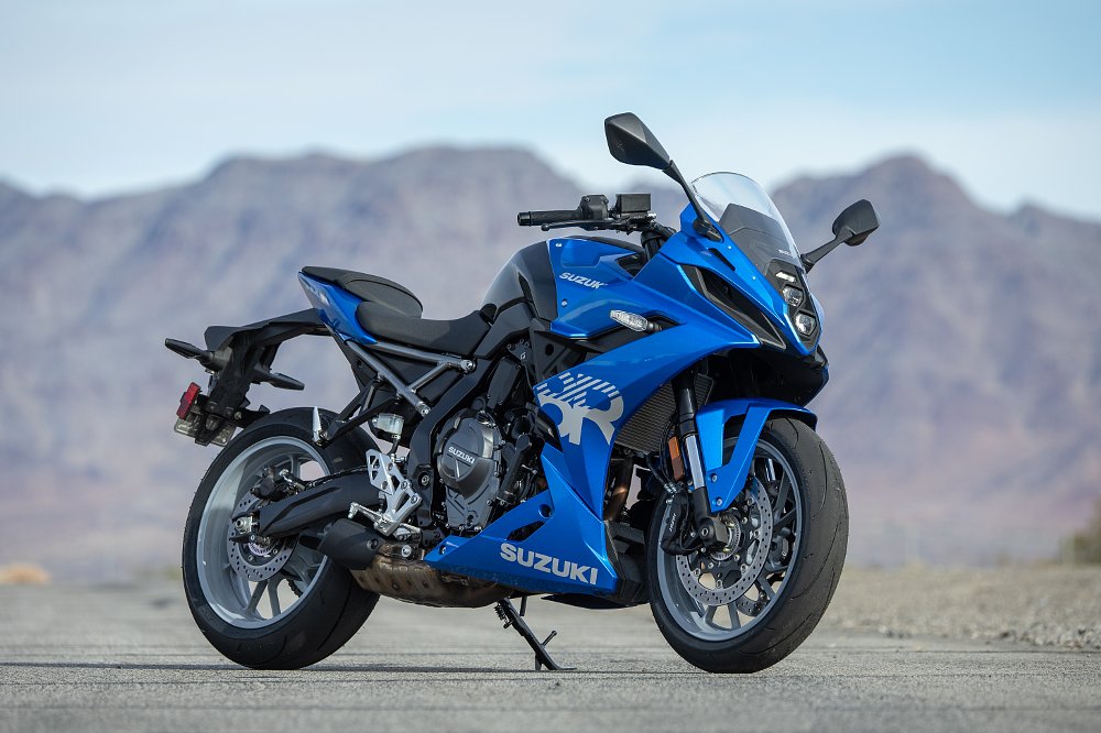 2024 Suzuki GSX-8R parked on its kickstand at a race track.