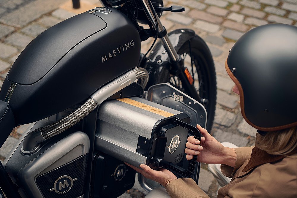 An RM2 rider removes the motorbike's electric battery.