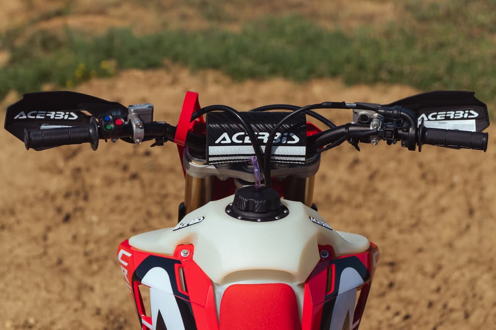 Rider standing on bike with Acerbis tank